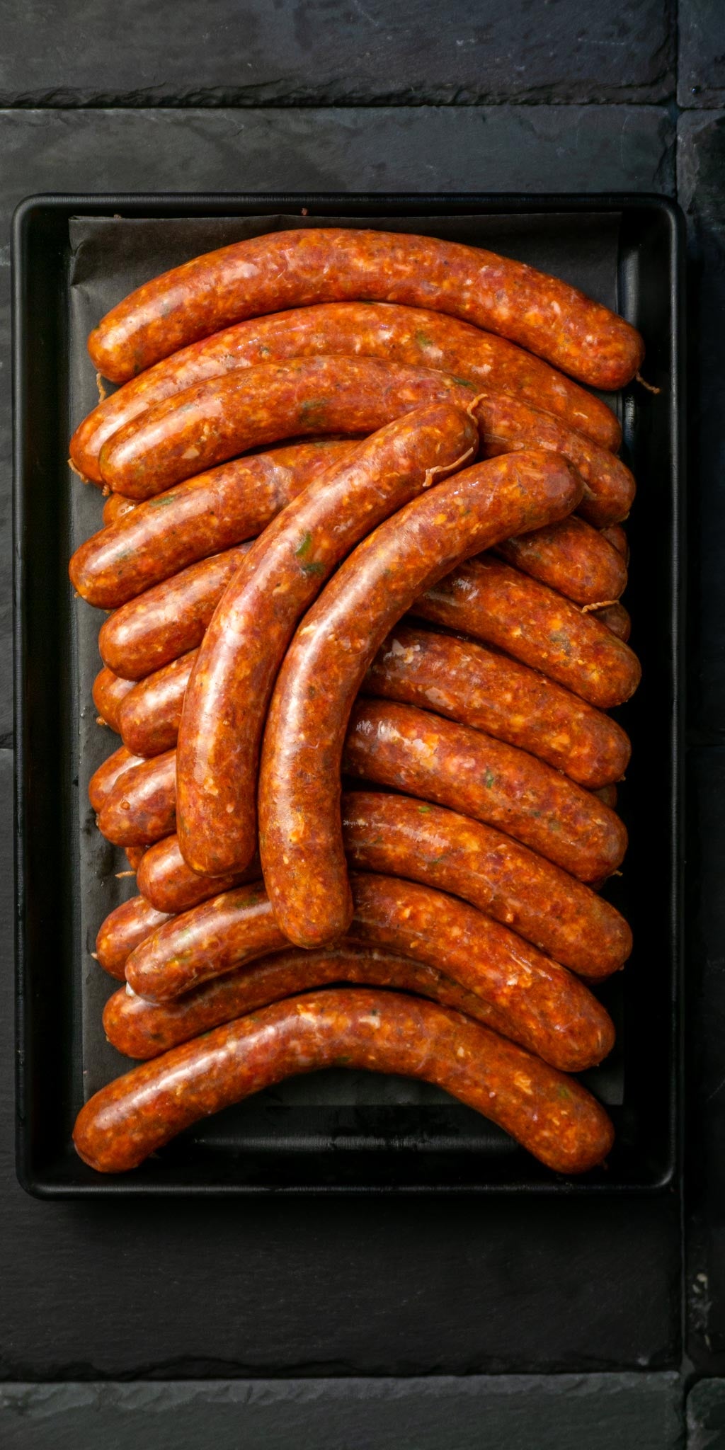 Merguez sausages on black plate